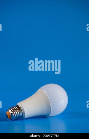Energy-saving LED light bulb on a blue background Stock Photo