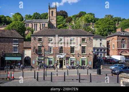 The Tontine Hotel  and village church seen from the Iron Bridge in Ironbridge, Shropshire, UK on 19 May 2024 Stock Photo