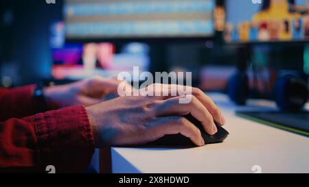 Photo editor color correcting photographs in creative studio using mouse and keyboard, close up shot. Photographer selecting best pictures for editorial content using retouching software, zoom in Stock Photo