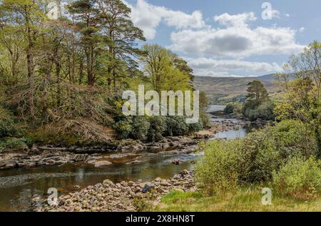 View down a stony river as it makes its way to a sea lough in the west of Ireland Stock Photo