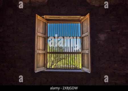 Old window with bars and blinds in an old fort in Texas Stock Photo