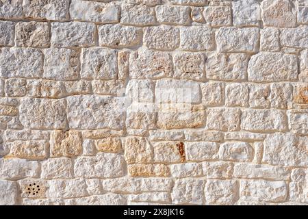 Background from an old natural stone wall seen in Italy Stock Photo