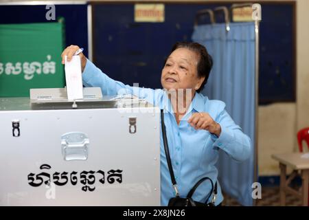 Phnom Penh. 26th May, 2024. A voter puts her ballot paper in a ballot box during local council elections in Phnom Penh, Cambodia, on May 26, 2024 The municipal, provincial, town and district council elections for the fourth term kicked off in Cambodia on Sunday, with five political parties taking part in the race, a National Election Committee (NEC) spokesperson said. Credit: Sovannara/Xinhua/Alamy Live News Stock Photo