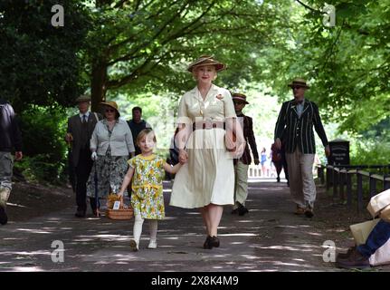 Ironbridge, Telford, UK. 26th May, 2024. World War Two weekend in the Ironbridge Gorge. A walk in the park for stylish 1940s reenactors lead by Miss Vintage Uk Sarah Goodlad and her daughter Margo. Sarah who also is known as the vintage sewer makes all her own 1940s style clothes. Credit: Dave Bagnall /Alamy Live News Stock Photo