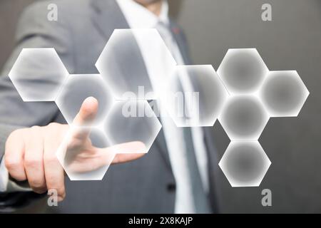 Person touching an hexagonal button on a digital interface. Concept about technology and choices Stock Photo