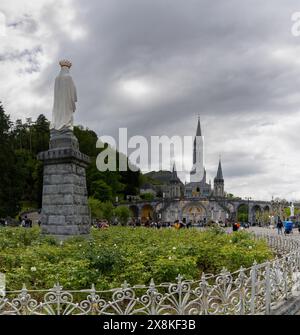 Lourdes, France - 17 April, 2024: view of the Our Lady of Lourdes statue in front of the sanctuary Stock Photo