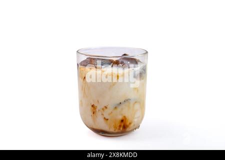 Frozen coffee cubes in a glass with milk, isolated on white Stock Photo