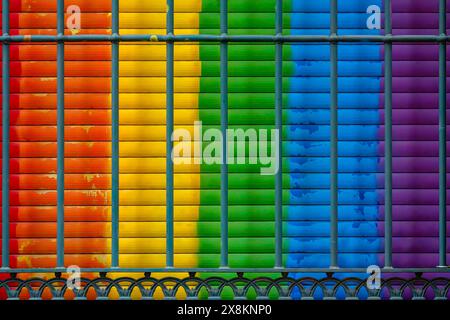 Metal grate in front of the rainbow colored window blinds Stock Photo