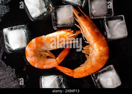 Shrimp on a black mica plate with ice cubes. High quality photo Stock Photo