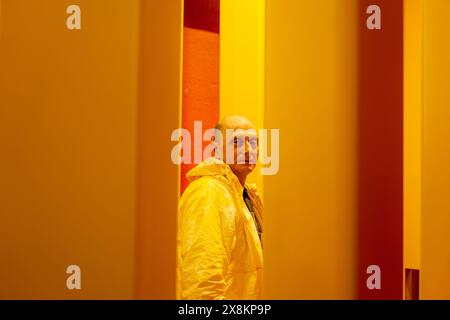 Perm, Russia - May 23, 2024: male worker in an industrial paint spray booth Stock Photo