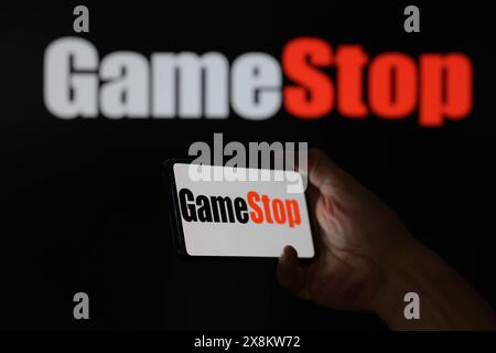 Brussels, Belgium. 25th May, 2024. GameStop logo is displayed on a smartphone with GameStop visible on screen in the background in this photo illustration. Taken in Brussels, Belgium. On May 25, 2024. (Jonathan Raa/Sipa USA) *** Strictly for editorial news purposes only *** Credit: Sipa USA/Alamy Live News Stock Photo