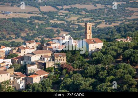 Aregno, Haute-Corse, Corsica, France. View over village rooftops from hillside, bell-tower of the Église Saint-Antoine-Abbé prominent. Stock Photo