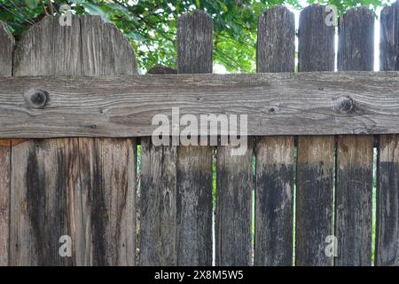 Closeup of old weathered wood rustic fence with some broken planks Stock Photo