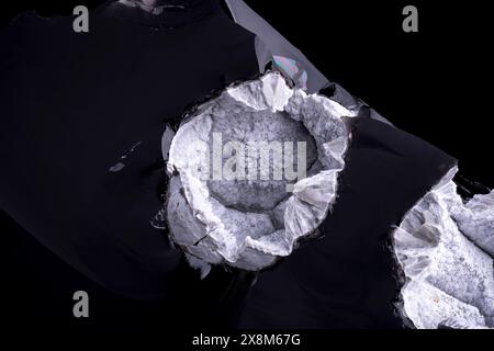 White Cristobalite on obsidian, Some green, brown fayalite present. From Cougar Butte, Cascade Range, Siskiyou County, California, USA Stock Photo