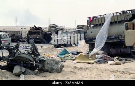 5th March 1991 Wrecked and burnt-out military vehicles and weapons, part of an Iraqi convoy that was attacked with cluster bombs by the USAF about a week before on Route 801, the road to Um Qasr, north of Kuwait City. Stock Photo