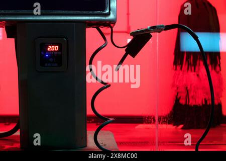 A car air compressor for tires is available at a car wash service and gas station, even at night. Stock Photo