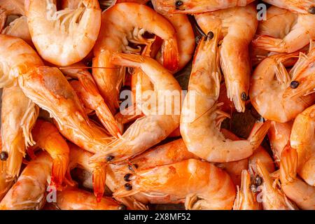 Frozen, boiled shrimp. Texture King prawns background. Seafood on the counter. Fish market. Close-up shot of seafood. Photo of shrimp in a supermarket Stock Photo