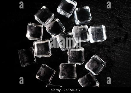 Ice cubes on a black background. transparent ice on a stone. High quality photo Stock Photo