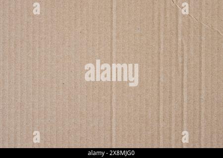 Brown cardboard texture background. Packaging material as abstract backdrop image. Empty carton pattern with stripes and wrinkle lines. Stock Photo