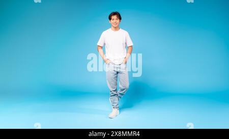 Guy Standing in Front of Blue Background Stock Photo