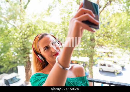 A woman is taking a selfie with her cell phone Stock Photo