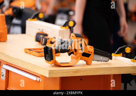 Electric tool for construction of wooden house. Stock Photo