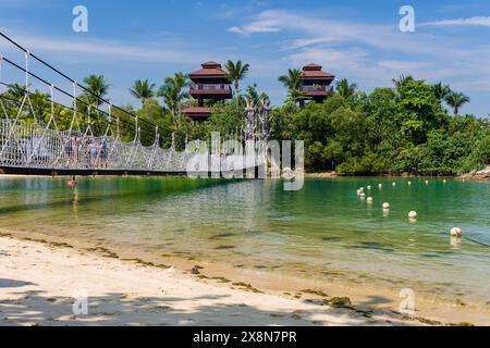SINGAPORE - APRIL 08 2024: Golden sand and lush vegetation on the tropical Palawan Beach on Sentosa island, Singapore Stock Photo