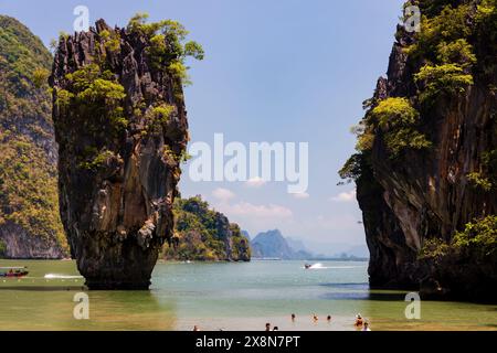 PHANG NGA, THAILAND - MARCH 31 2023: Tourists exploring the beach and limestone formation of Ko Tapu (James Bond Island) in Phang Nga Bay Stock Photo