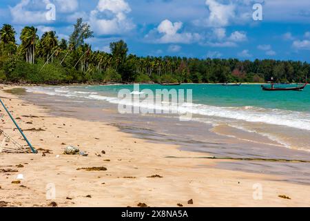 Plastic bottles and other pollution washed up onto a tropical beach by the tide  in asia Stock Photo