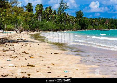 Plastic debris and bottles washed up onto a tropical beach on the andaman coast of Thailand Stock Photo