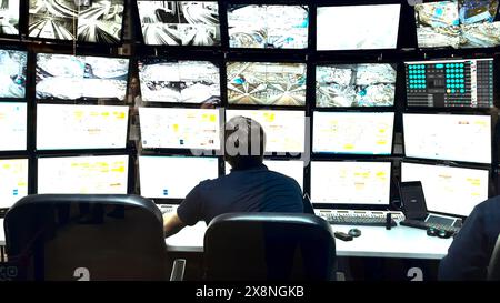 Traffic Office with monitors. Media. Traffic data on monitors in city planning office. Employee monitors monitors from traffic surveillance cameras in Stock Photo