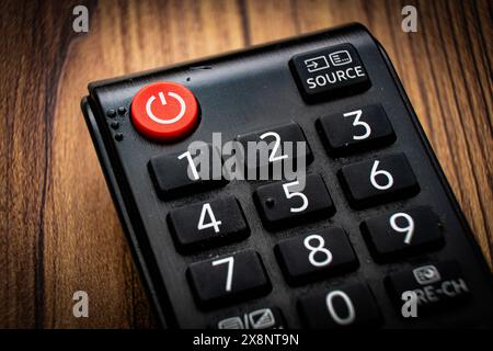 red shut off button on a remote control powering down shutting of concept Stock Photo
