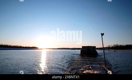 Time lapse effect, barge towing down the river. Clip. Concept of water goods transportation. Stock Photo