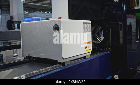 Automated laser cutting machine for metal pipes. Media. Moving machine on rails of industrial conveyor. Automated laser machine moving in industrial Stock Photo