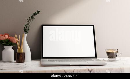 A laptop computer white-screen mockup, a coffee cup, a reed diffuser, and flower vases on a white marble table against the white wall. a modern home o Stock Photo