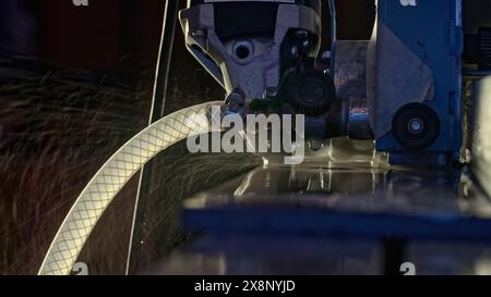 A worker saws ceramic tiles with a grinder. Creative. Cutting ceramics with machine and water to avoid dust. Stock Photo