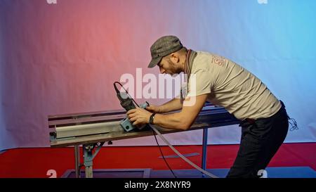 The process of cutting porcelain stoneware slabs with a hydraulic cutter. Creative. Preparation of tiles for laying on walls or floors. Stock Photo
