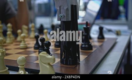Man is playing chess with robot. Media. Man is playing chess against robot at exhibition. Artificial intelligence technologies versus humans Stock Photo