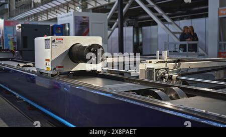 Automated laser cutting machine for metal pipes. Media. Moving machine on rails of industrial conveyor. Automated laser machine moving in industrial Stock Photo
