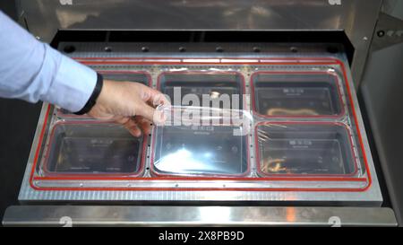 One-off package and pack. Goods manufactured oOne off plastic packages production, industrial background. Media. Close up of manager hands checking Stock Photo