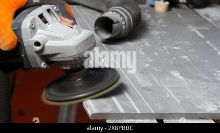 Process of grinding raw wood plank with angle grinder in workshop. Creative. Flying wood dust while polishing timber surface. Stock Photo