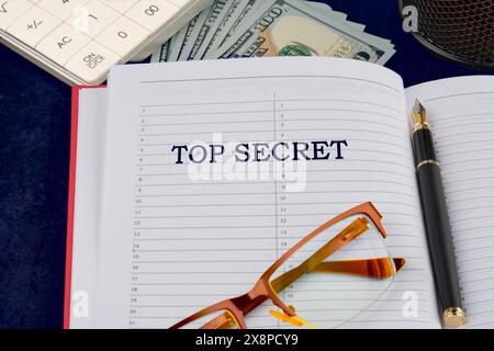 Search, disclosure or finding of top secret confidential information. The text top secret in the businessman's notebook Stock Photo