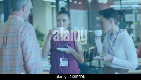 A diverse group of professionals and intern having coffee break in a modern office Stock Photo