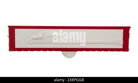 Narrow rectangular white paper with red frame torn from a box packaging on white background with clipping path Stock Photo