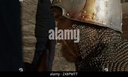 Medieval old knight helmet and chain mail for protection in battle. Media. Close up side view of a man in very heavy headdress, middle ages armor Stock Photo