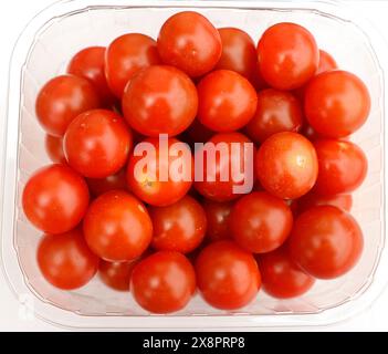 close up of a box with red cherry tomatoes Stock Photo