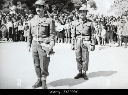 Greek Civil War era Hellenic Army officers in front of a crowd. Stock Photo