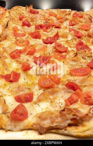 Stuffed Pizza Tray with Fresh Cherry Tomatoes and Sliced Pork. Stock Photo