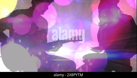Image of colourful spots moving over silhouette of man and women playing guitar and drums Stock Photo
