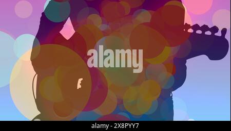 Image of colourful spots moving over silhouette of man playing guitar Stock Photo